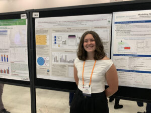 Female student standing in front of research poster